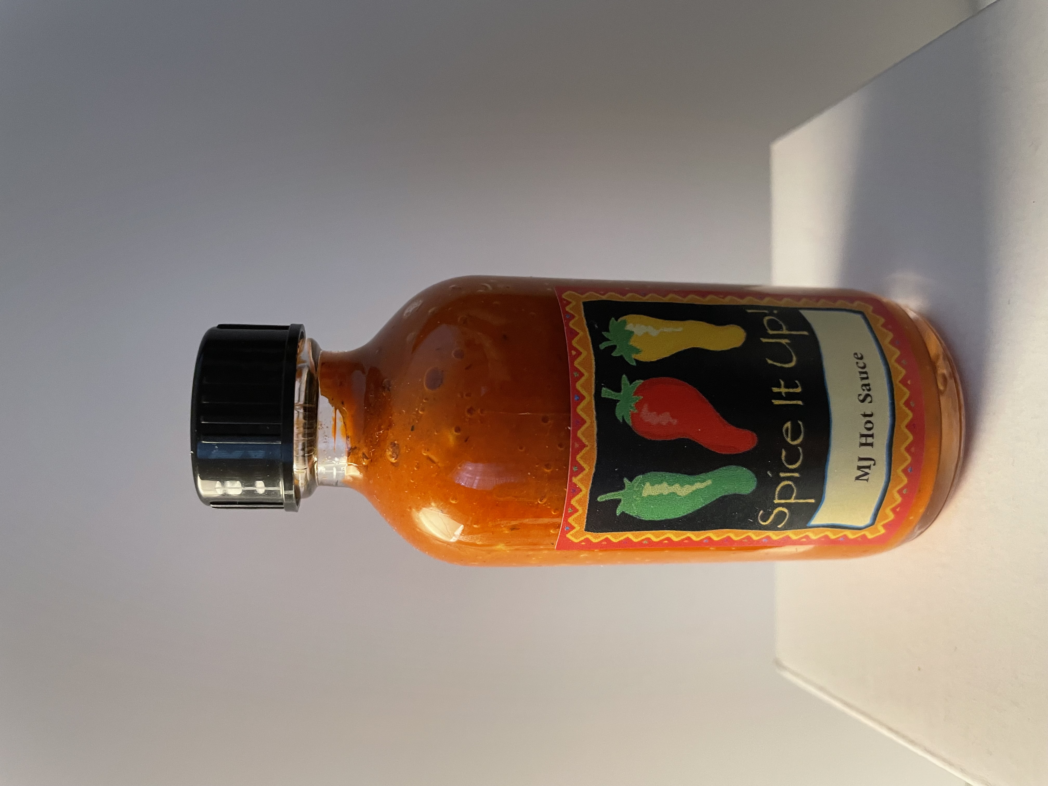 Collection of MJ's Hot Sauce bottles arranged artistically